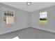 Bright bedroom with gray carpet and two windows at 1356 Flora Dr, Conyers, GA 30094