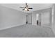Main bedroom with ceiling fan and access to bathroom at 1356 Flora Dr, Conyers, GA 30094