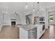 Island kitchen open to Gathering room with hardwood floors and fireplace at 1356 Flora Dr, Conyers, GA 30094