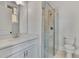 Clean bathroom with white vanity, walk-in shower, and tile flooring at 1356 Flora Dr, Conyers, GA 30094