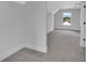 Bright bonus room featuring a large window and gray carpeting at 1356 Flora Dr, Conyers, GA 30094
