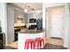 Modern kitchen with gray cabinets, black appliances, and a breakfast bar at 401 16Th Nw St # 1157, Atlanta, GA 30363