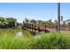 Modern footbridge over a tranquil pond in a community setting at 401 16Th Nw St # 1157, Atlanta, GA 30363