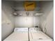 Laundry closet with washer, dryer, and shelving at 401 16Th Nw St # 1157, Atlanta, GA 30363