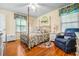 Bedroom with hardwood floors, ceiling fan, and comfortable seating at 2690 Hideaway Hills Sw Ln, Powder Springs, GA 30127