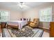 Bright bedroom with wood flooring, a comfy chair, and a window at 2690 Hideaway Hills Sw Ln, Powder Springs, GA 30127