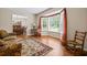 Living room with hardwood floors, bay window, and comfortable seating at 2690 Hideaway Hills Sw Ln, Powder Springs, GA 30127
