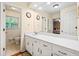 Clean bathroom with double vanity and a large mirror at 2690 Hideaway Hills Sw Ln, Powder Springs, GA 30127