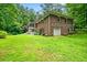 Brick house exterior with attached garage and large yard at 2690 Hideaway Hills Sw Ln, Powder Springs, GA 30127