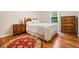 Bedroom with hardwood floors, dresser, and a rug at 2690 Hideaway Hills Sw Ln, Powder Springs, GA 30127