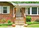 Brick front entrance with stone steps and white door at 2690 Hideaway Hills Sw Ln, Powder Springs, GA 30127