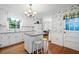 Kitchen with white cabinets, island, and hardwood floors at 2690 Hideaway Hills Sw Ln, Powder Springs, GA 30127