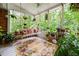 Screened porch with swing and numerous potted plants at 2690 Hideaway Hills Sw Ln, Powder Springs, GA 30127