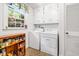 Laundry room with washer, dryer, and shelving at 2690 Hideaway Hills Sw Ln, Powder Springs, GA 30127