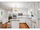 Bright kitchen with white cabinets, granite island, and stainless steel appliances at 2690 Hideaway Hills Sw Ln, Powder Springs, GA 30127