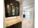 Butlers pantry with granite countertop and glass-front cabinets at 4070 Annecy Sw Dr, Atlanta, GA 30331