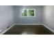 Well-lit bedroom with dark hardwood floors and window at 2492 Brentwood Ct, Decatur, GA 30032
