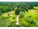 Aerial view of house, expansive yard, and surrounding woods at 3545 Liberty Rd, Villa Rica, GA 30180