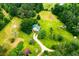 House nestled in a lush green landscape, seen from an aerial perspective at 3545 Liberty Rd, Villa Rica, GA 30180