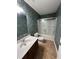 Bathroom with shower/tub combo, single vanity, and nature wallpaper at 231 Madison Ave, Acworth, GA 30102