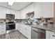 Modern kitchen featuring white cabinets, granite countertops, and stainless steel appliances at 810 Powder Springs Se St, Smyrna, GA 30080