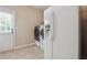 Laundry room with refrigerator, washer, and dryer at 6925 Keswick Ct, Cumming, GA 30040