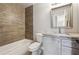 Updated bathroom with granite vanity, tiled shower, and modern fixtures at 6925 Keswick Ct, Cumming, GA 30040