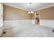 Elegant dining room boasts wainscoting and a chandelier at 6925 Keswick Ct, Cumming, GA 30040
