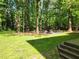 Wooded backyard with a fire pit and seating area at 6925 Keswick Ct, Cumming, GA 30040