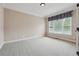 Bright office features neutral walls, carpeting, and window with blinds at 6925 Keswick Ct, Cumming, GA 30040