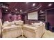 Finished basement home theater with seating, large screen, and built-in shelving at 6925 Keswick Ct, Cumming, GA 30040