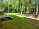 Spacious backyard with a firepit, seating area, and lush greenery at 6925 Keswick Ct, Cumming, GA 30040