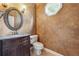 Elegant powder room with dark vanity and decorative mirror at 6925 Keswick Ct, Cumming, GA 30040