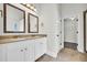 Double vanity bathroom with granite countertop and walk-in closet at 1216 Trophy Club Ave, Dacula, GA 30019
