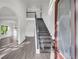 Bright entryway with gray hardwood floors and modern staircase at 1216 Trophy Club Ave, Dacula, GA 30019