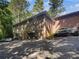 Rear view of building showcasing parking and multiple units with stairs at 2416 Peachwood Ne Cir # 9, Atlanta, GA 30345