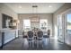 Bright dining room with wood table, gray chairs, and large windows at 1725 Prospect Way, Conyers, GA 30094