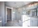 Bathroom with a large, glass-enclosed shower and marble tile at 1725 Prospect Way, Conyers, GA 30094