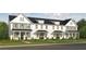 Three-unit townhome building with farmhouse style and landscaping at 1725 Prospect Way, Conyers, GA 30094