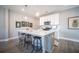 Modern kitchen with white cabinets, quartz island, and stainless steel appliances at 1725 Prospect Way, Conyers, GA 30094