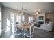 Open concept living room and dining area with fireplace and wood floors at 1725 Prospect Way, Conyers, GA 30094