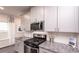 Kitchen boasts granite countertops and stainless steel gas cooktop at 1600 Flint River Place Se Se Pl, Smyrna, GA 30126