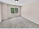 Well-lit bedroom with carpet flooring and a large window at 4206 Weavers White Ln # 17, Austell, GA 30106