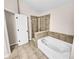 Main bathroom with a soaking tub, shower, and tile flooring at 4206 Weavers White Ln # 17, Austell, GA 30106