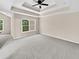 Main bedroom with tray ceiling, carpet, and window at 4206 Weavers White Ln # 17, Austell, GA 30106