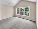 Bright bedroom featuring gray carpet and three windows at 4206 Weavers White Ln # 17, Austell, GA 30106