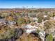 Aerial view of houses nestled amongst fall trees with a city skyline at 1112 Delaware Se Ave, Atlanta, GA 30316