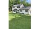 Two story house with white siding, gray roof, and landscaping at 4604 Shumart Dr, Snellville, GA 30039