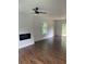 Living room with hardwood floors, fireplace, and ceiling fan at 4604 Shumart Dr, Snellville, GA 30039