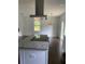 Kitchen with island, stainless steel range hood, and hardwood floors at 4604 Shumart Dr, Snellville, GA 30039